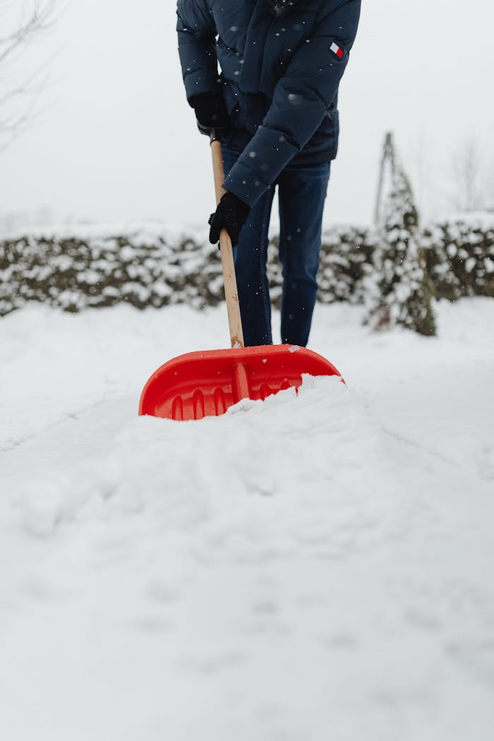 Snow removal professional clearing a residential driveway in Laval